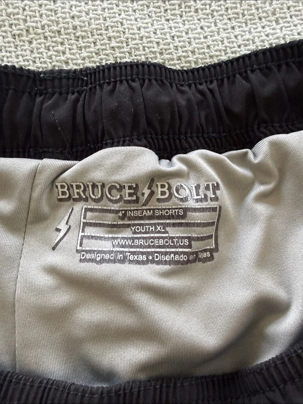 Youth Bruce Bolt black athletic shorts with built in liner